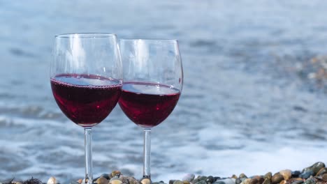 red wine glasses on the beach