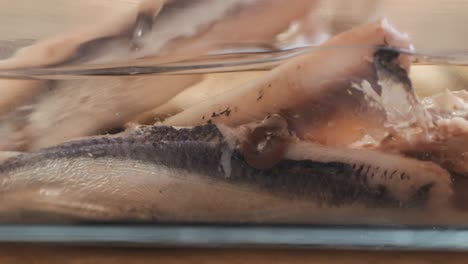 fresh sea sardines and anchovy fish and mullus on display on ice on market store shop. seafood fish background, close up stand of small salty white fish.