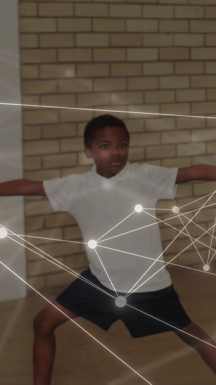 Vertical video: Glowing nodes appearing on blue mat, boy shifting, web linking students for school
