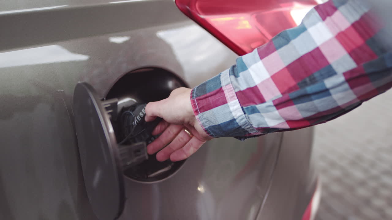 Person Filling a Car with Gas