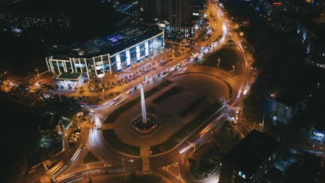 night timelapse of сircular intersection traffic crossroad, aerial view