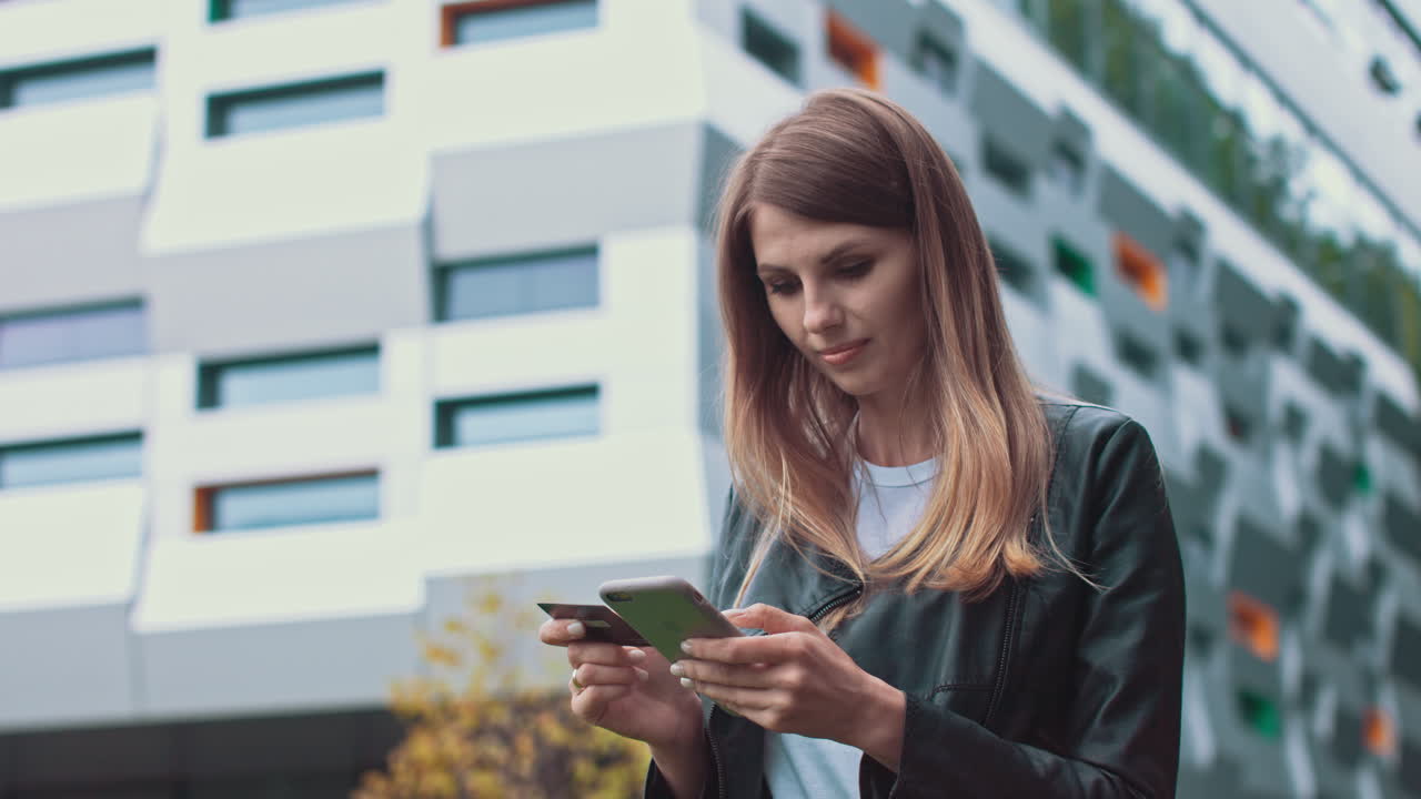 Woman using smartphone and credit card