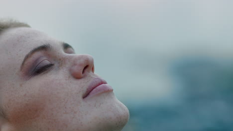 close-up-portrait-of-beautiful-young-woman-looking-up-praying-exploring-spirituality-contemplating-future-on-cloudy-seaside