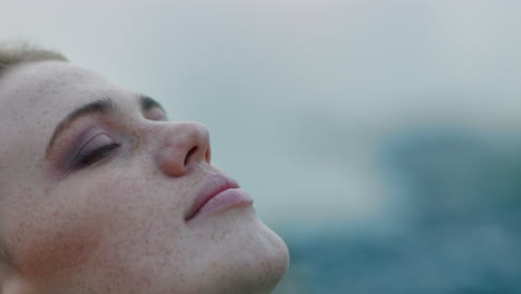 close up portrait of beautiful young woman looking up praying exploring spirituality contemplating future on cloudy seaside