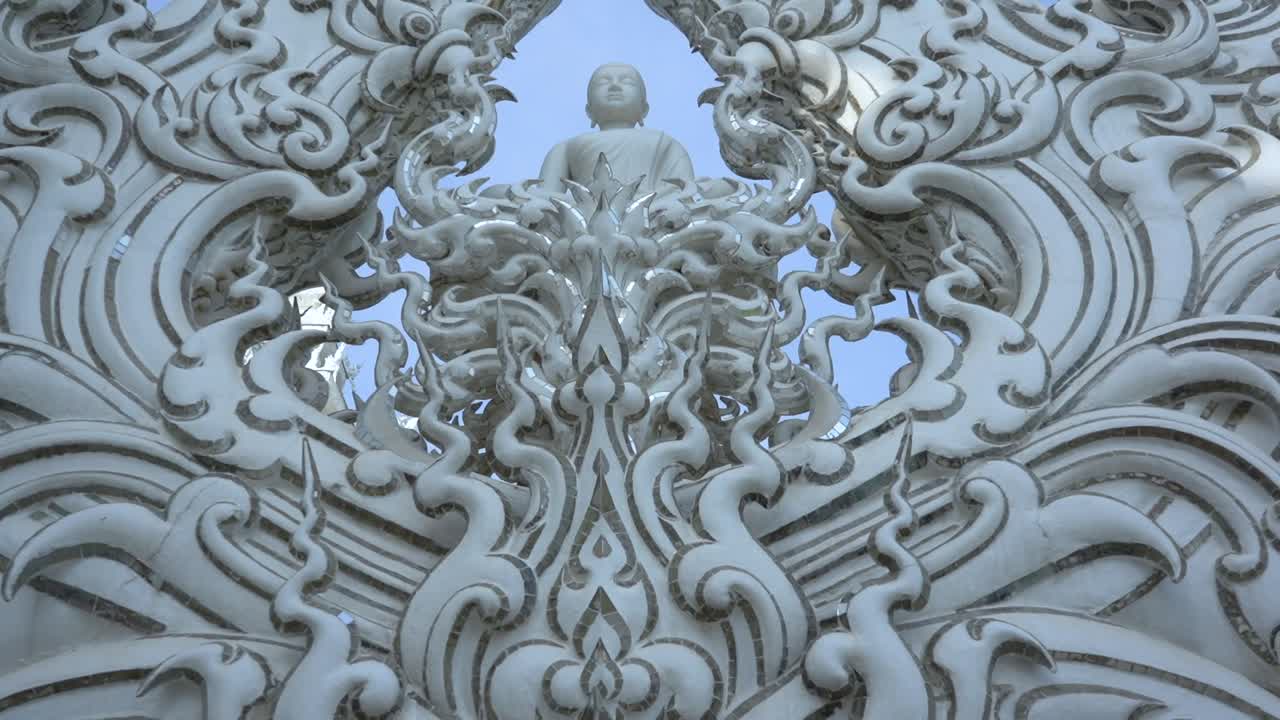 Tilt revelation of amazing intricate Buddha Statue in Chiang Rai, White Temple.