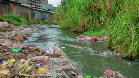 a river in an mathare slums located in kenya, africa, showing the pollution caused by improper waste management and climate change that has led to it being a hazardous place to be around