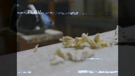 shredded paper on table with animation of static lines and play text overlay