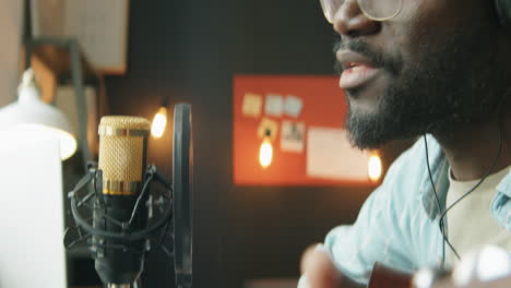 african american singer recording music at home studio
