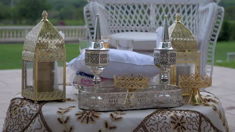 slow revealing shot of golden and silver candle holders as decoration at a wedding