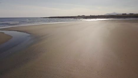 Low-Flight-over-Rare-Golden-Sandy-Beach-and-Ocean-During-Sunny-Summer-In-Snaefellsness-Peninsula,-Iceland