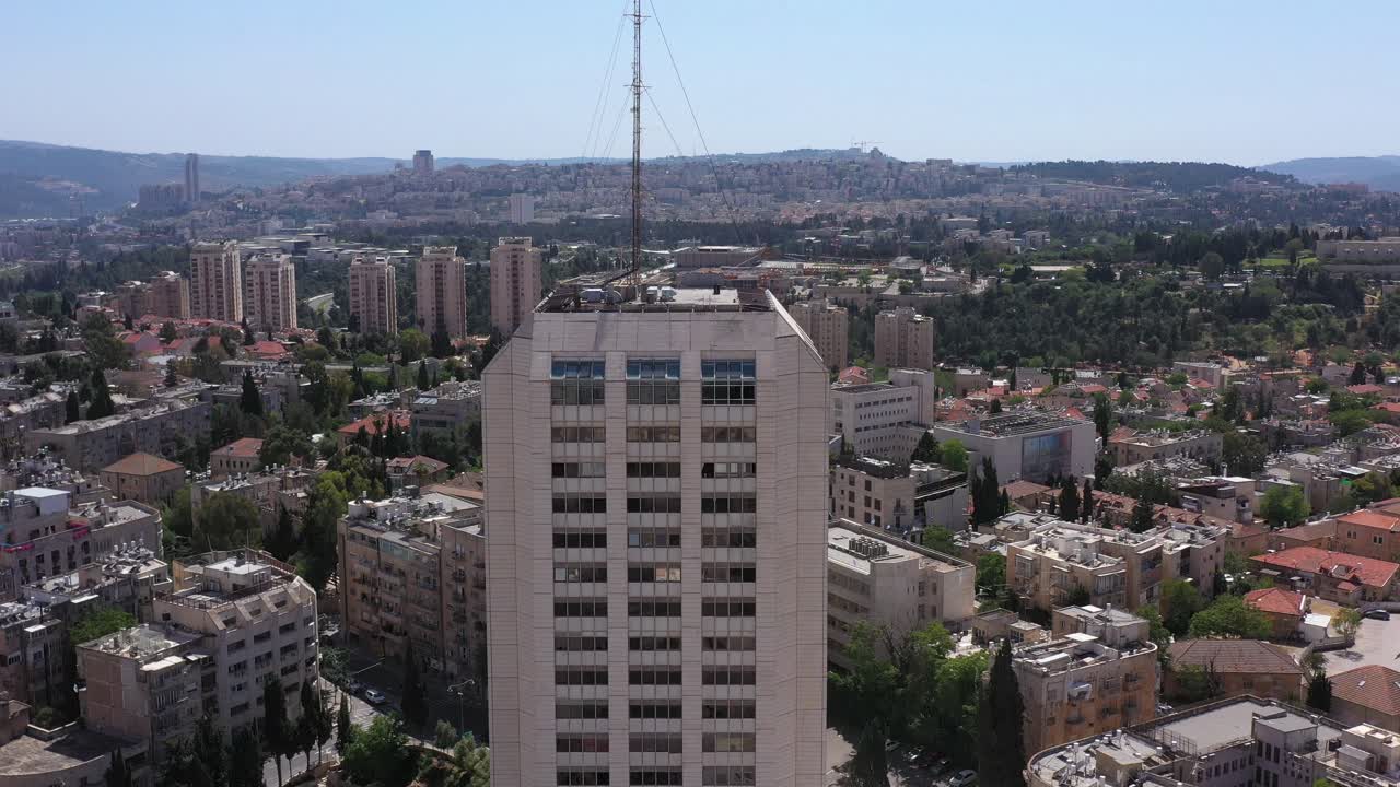 Aerial view of a city with a prominent high-rise building