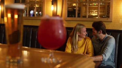 young couple in a bar together