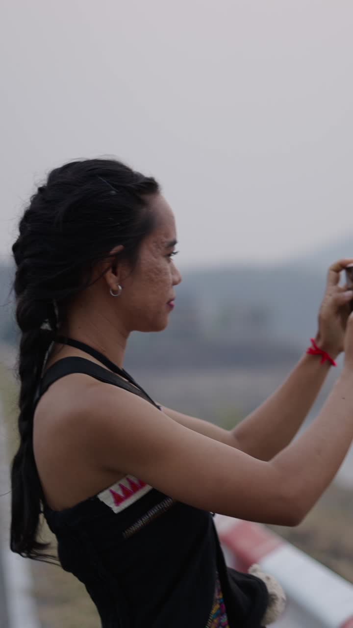 Woman taking a photo with her phone