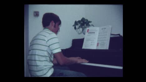 1971 handsome teen boy plays piano