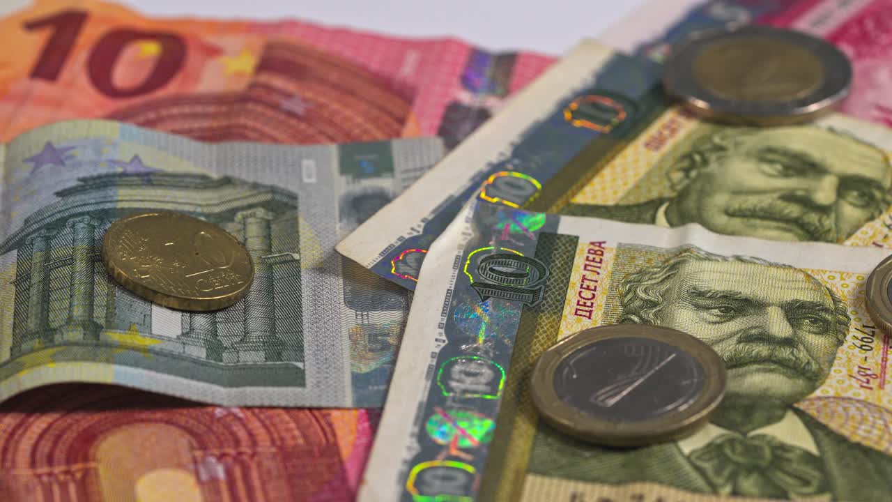 Currency notes and coins arranged on a flat surface for display