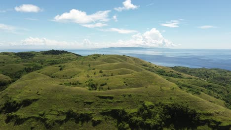 aerial establishing shot of the vast teletubbies hills in nusa peniuda