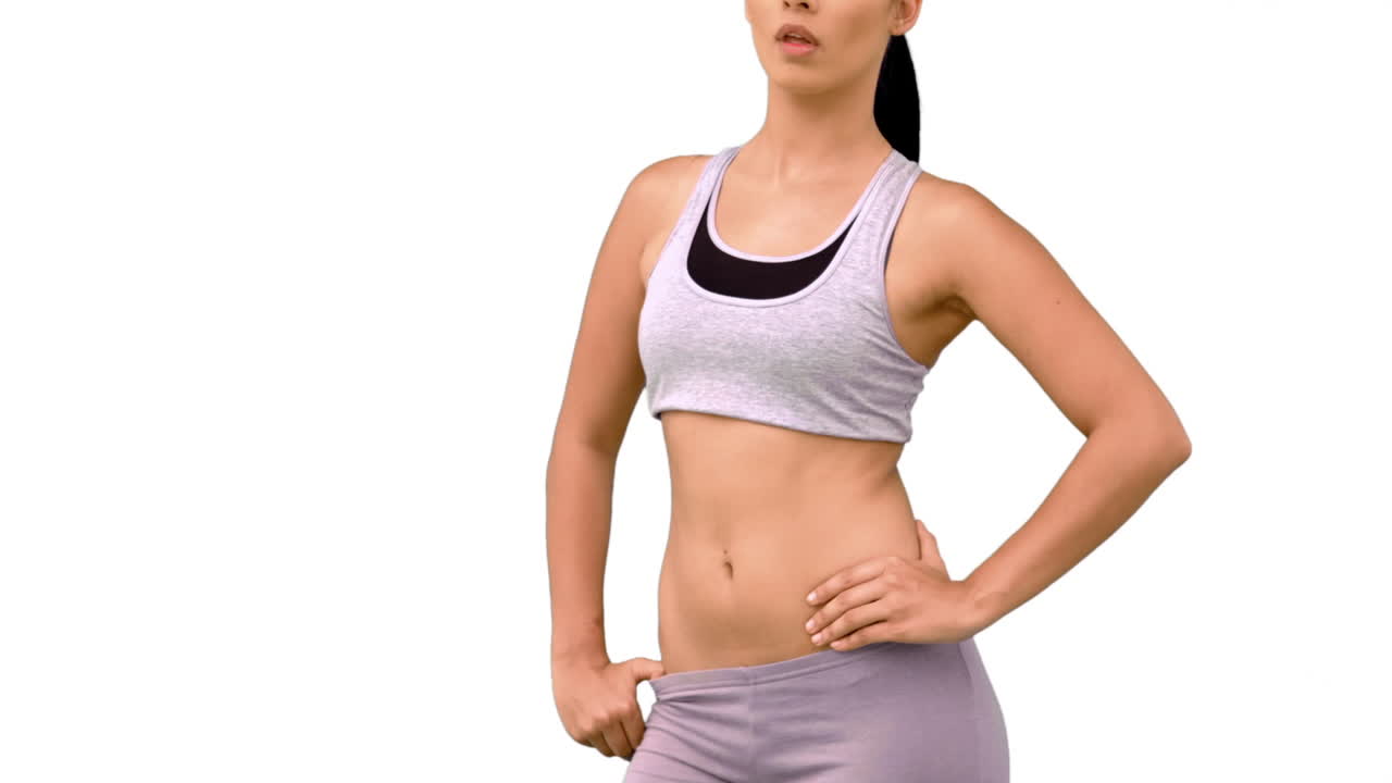 Fit woman striking a pose and tossing hair