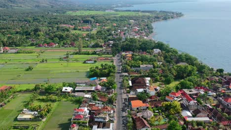 aerial panoramic view of road on lovina coastline in bali indonesia with beautiful ocean on sunny day