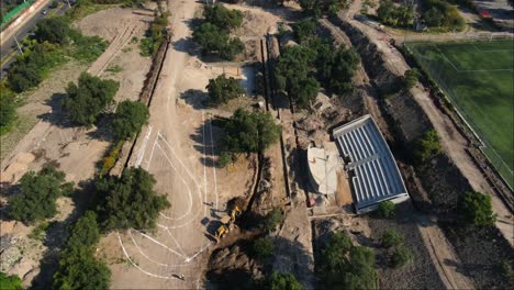 Drone-view-of-construction-building-a-city-park-in-Mexico-city,-4K-video