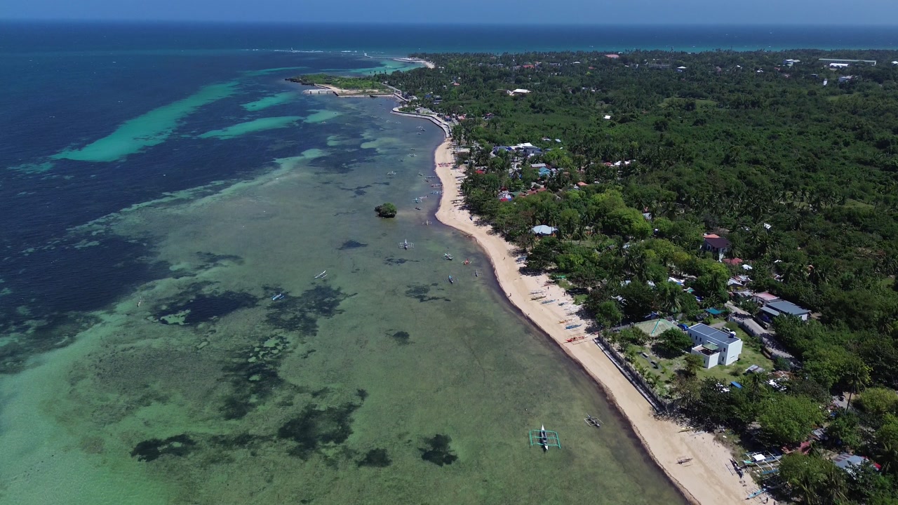 Wide aerial view of Bantayan Island showing an expansive tropical coastline with beaches greenery and surrounding ocean creating a scenic island landscape in the Philippines Southeast Asia