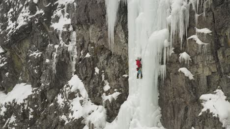 amazing aerial lone climber scaling ice cascade maineline, mount kineo 4k