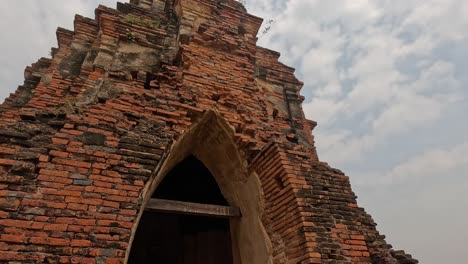 person walking through historic temple archway