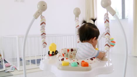 a little girl joyfully plays in a vibrant playroom while receiving attentive care.