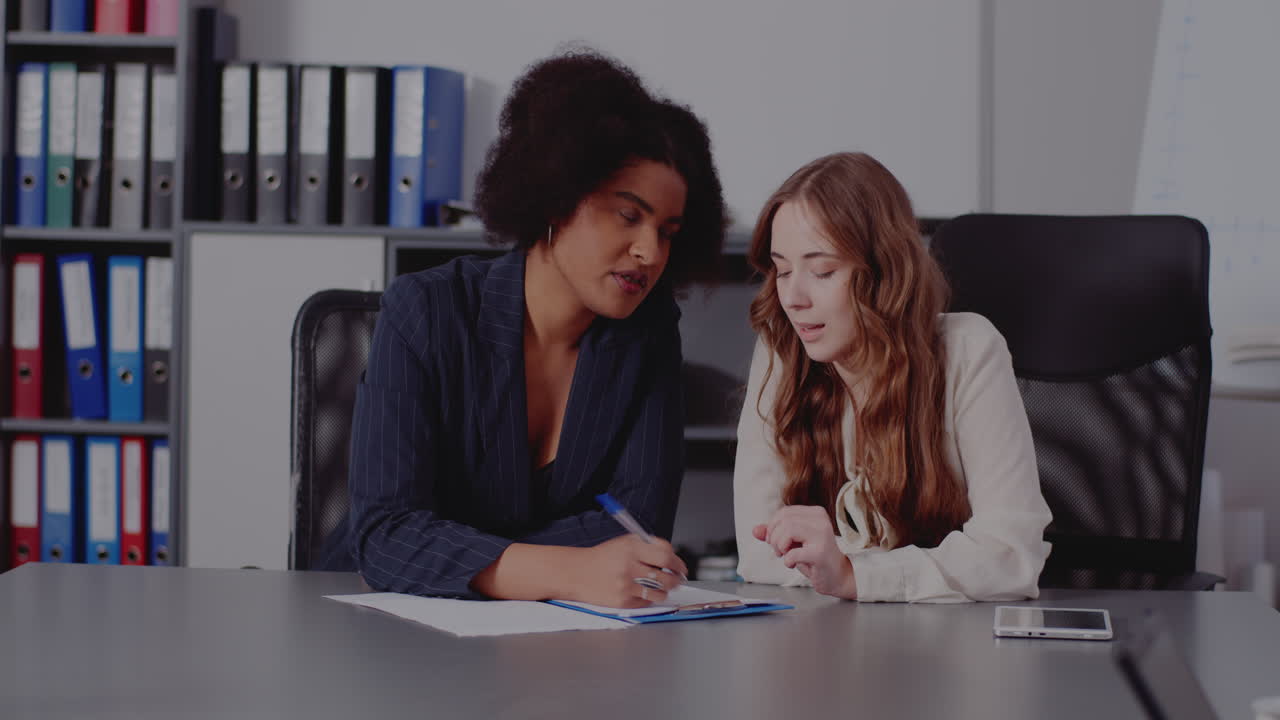 Two businesswomen collaborating in an office setting