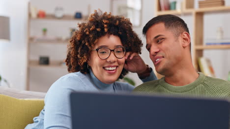 laptop, couple and happiness on sofa in home