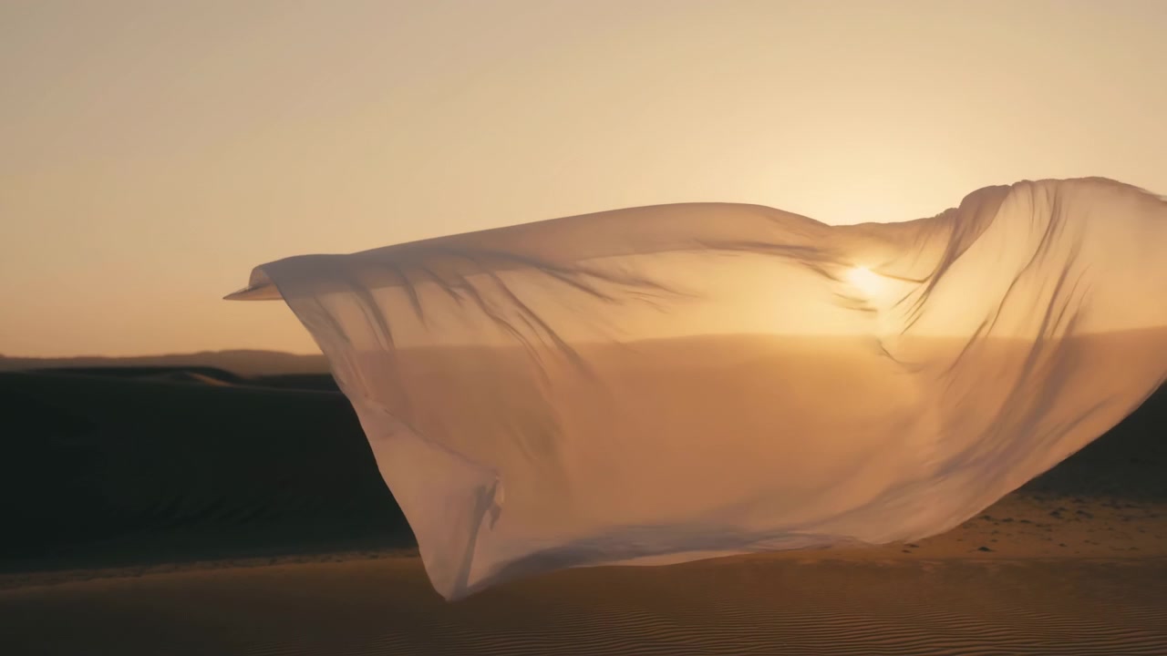 Translucent Fabric Floating Over Dunes At Sunset, Golden Light Filtering Through Sheer Cloth, Gentle Wind