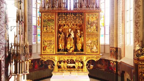 late gothic wooden golden altar in the catholic church with the apostles