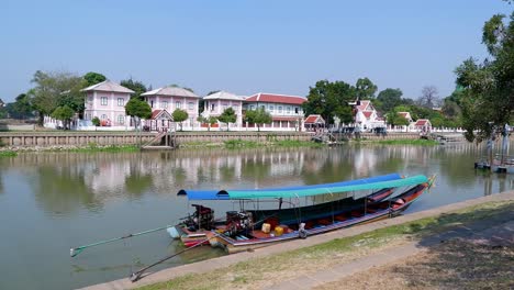 a long boat moves along a river