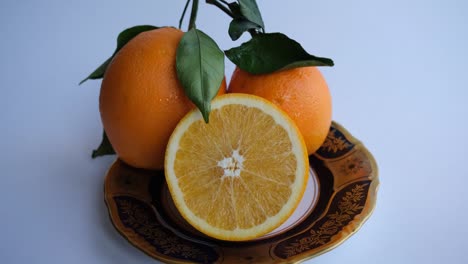 ripe and juicy orange. fresh orange cut in half on a background of oranges with leaves