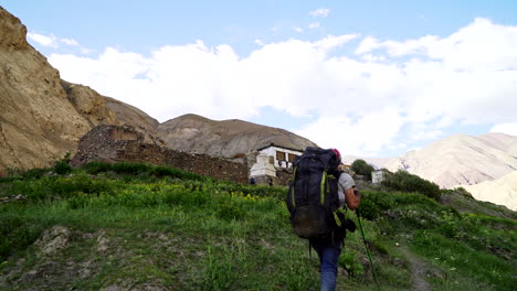 Man-with-backpack-arriving-to-Hankar,-on-the-Markha-Valley-trek