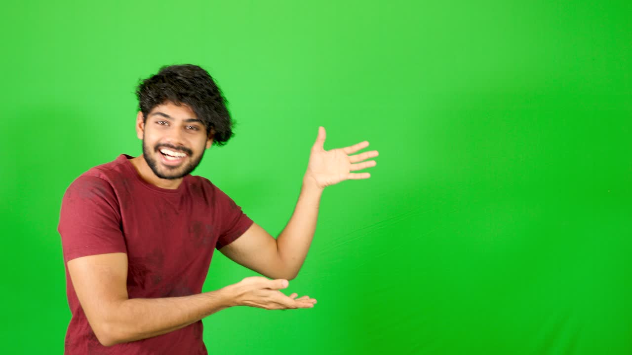 Indian guy point out with green background indian guy standing on green ...