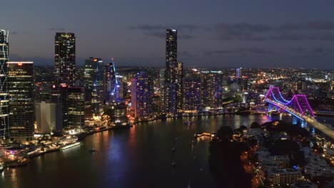 cityscape of brisbane with story bridge over brisbane river at night - 80 years anniversary of story bridge in brisbane cbd, queensland, australia