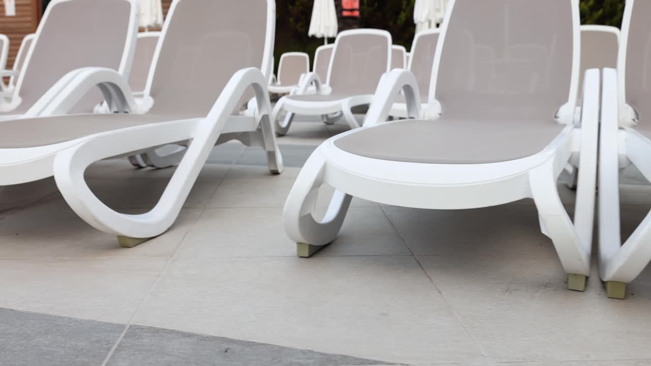 Empty Lounge Chairs by the Pool