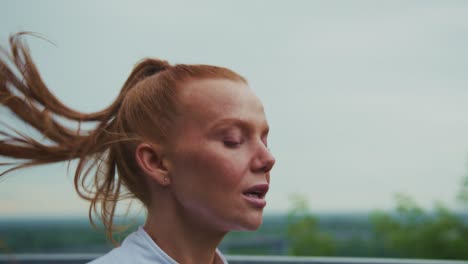 redhead woman exercising outdoors