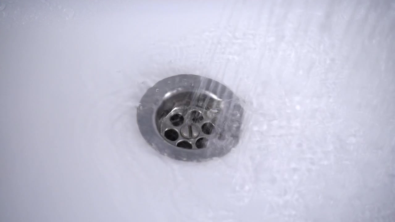 The water is washed into the water drain. Slow motion.