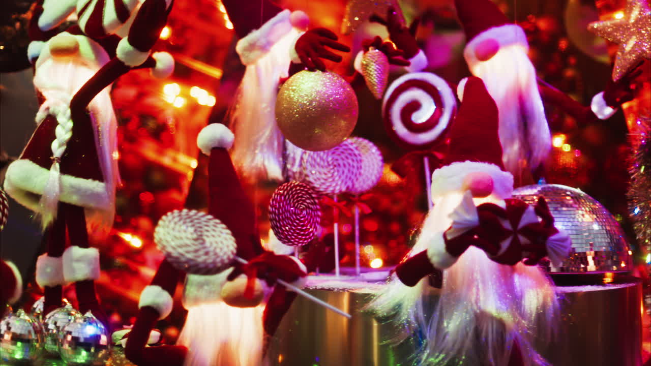 Multiple Santa Claus Christmas decorations moving in bubbles in the courtyard of the Monte Carlo Casino