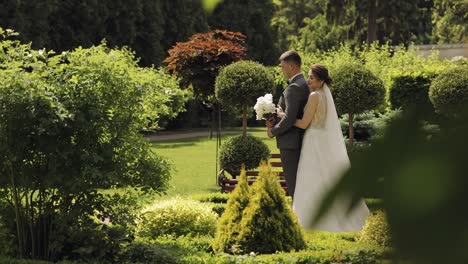 Lovely-newlyweds-caucasian-bride-and-groom-with-bouquet-in-park,-wedding-couple-first-meeting