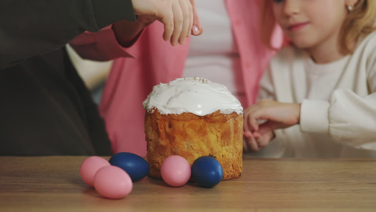 Children decorating Easter bread and eggs