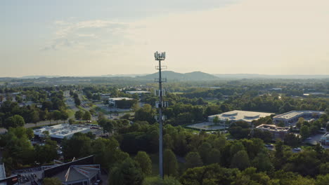 Aerial-view-orbiting-around-cell-phone-5G-radio-communication-tower,-4K