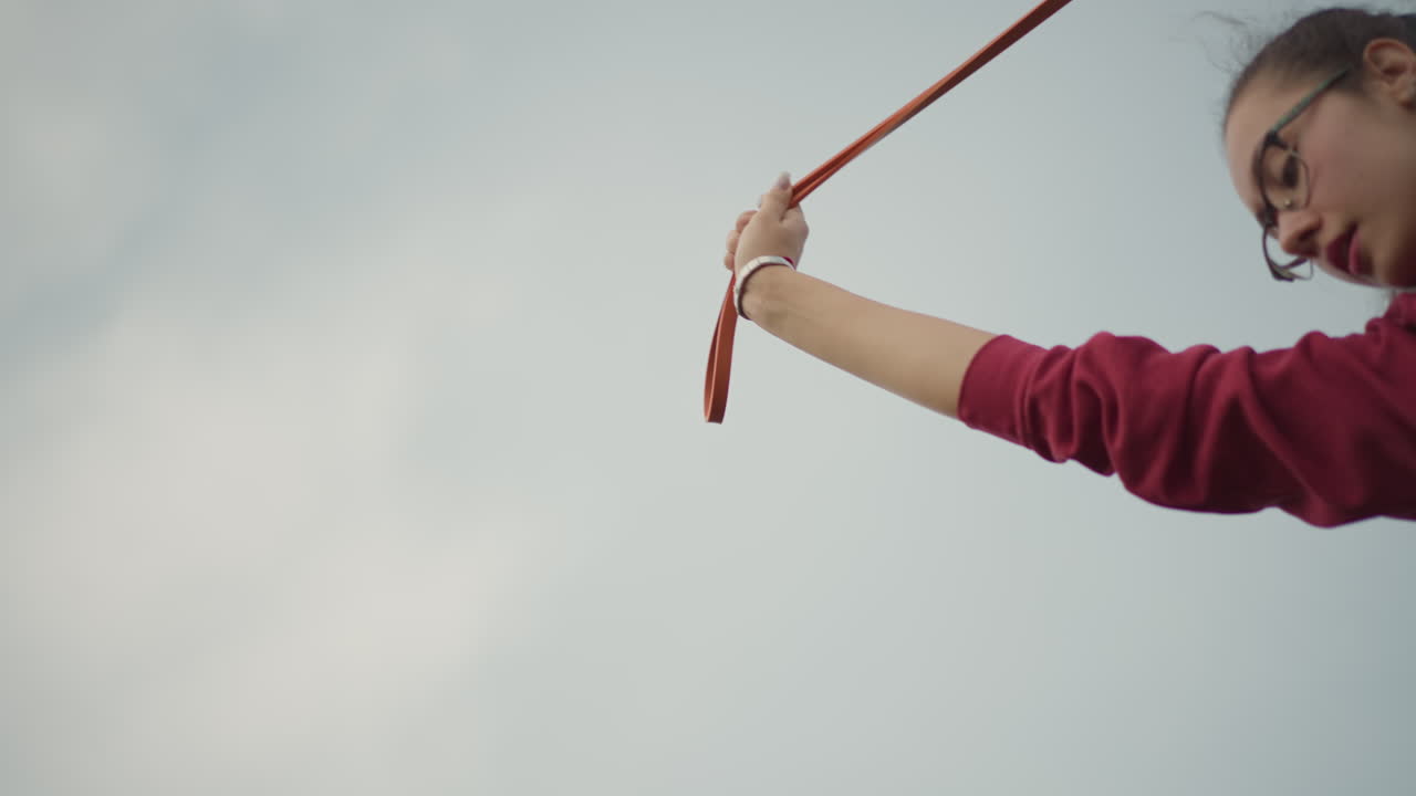 Empowered Asian Woman, Woman Displays Strength Against Cloudy Sky, Asian Female In Commanding Stance Under Overcast Sky, Resilient Woman In Powerful Pose With Steady Breath And Cloudy Backdrop