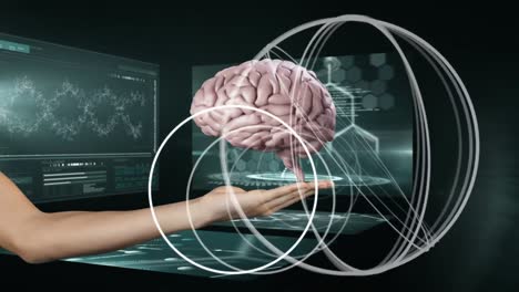 Animation-of-hand-holding-digital-brain-over-data-processing-on-black-background