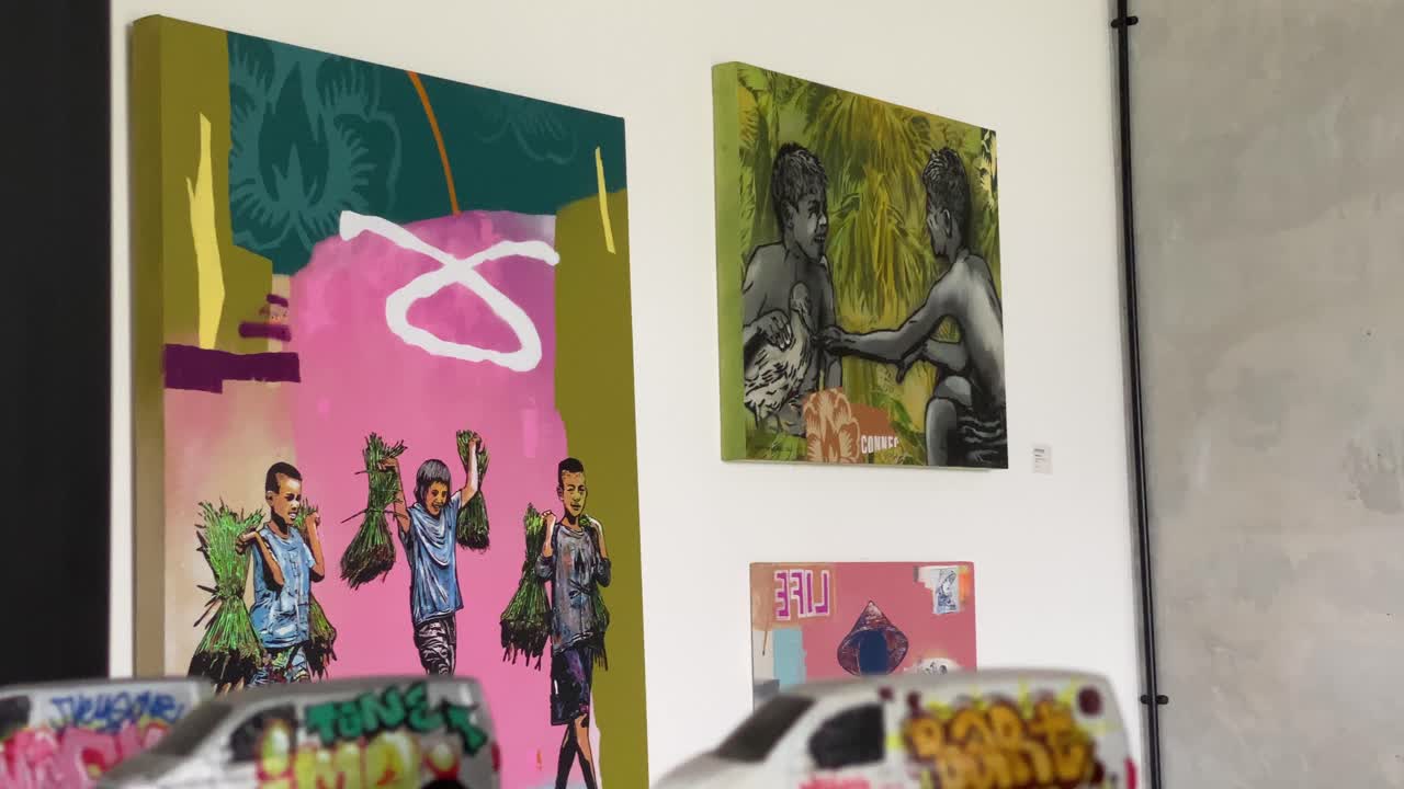 The footage shows the interior of a coffee shop that displays paintings and graffiti on every wall.