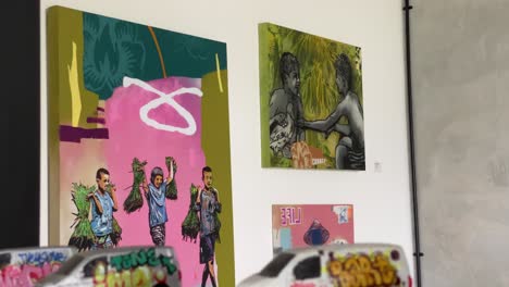 the footage shows the interior of a coffee shop that displays paintings and graffiti on every wall.