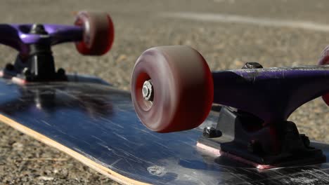 Skateboard-Flipped-Over-With-Wheel-Spinning-in-Parking-Lot-Extreme-Sports