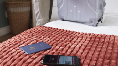 packing suitcase with passport and boarding pass, preparing for travel on bed