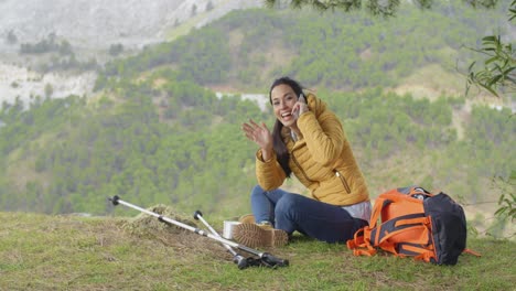 Happy-backpacker-on-phone-and-waving-hand